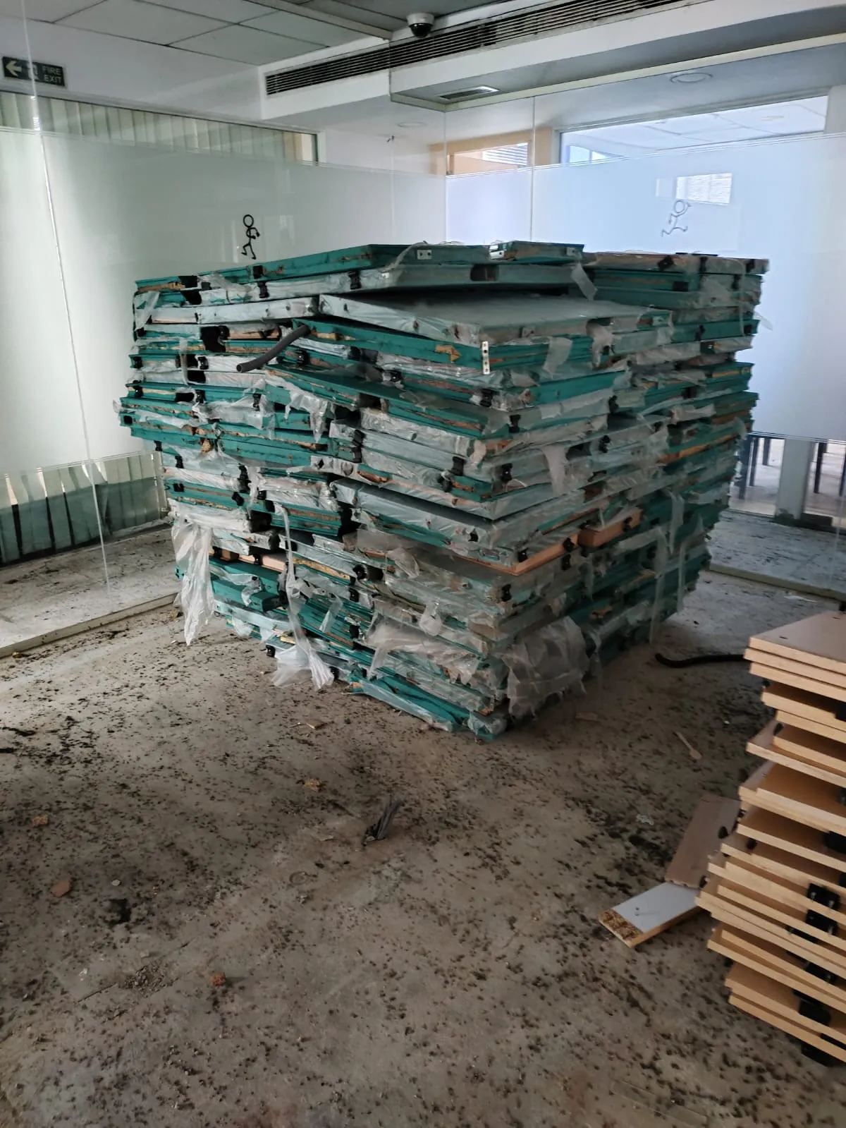 Acoustic Divider Staging | Office Partition Removal Marathahalli Protective wrapped stacks of fabric acoustics and partition divider boards optimized for office partition removal Marathahalli