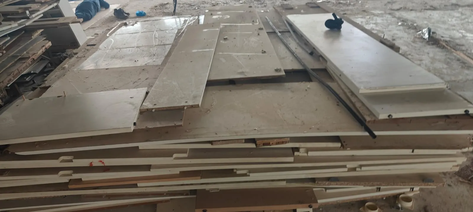 Commercial Material Logistics | Office Shifting Services Marathahalli Flat-pack structural table panels stacked neatly on a construction site during a premium office shifting services Marathahalli move